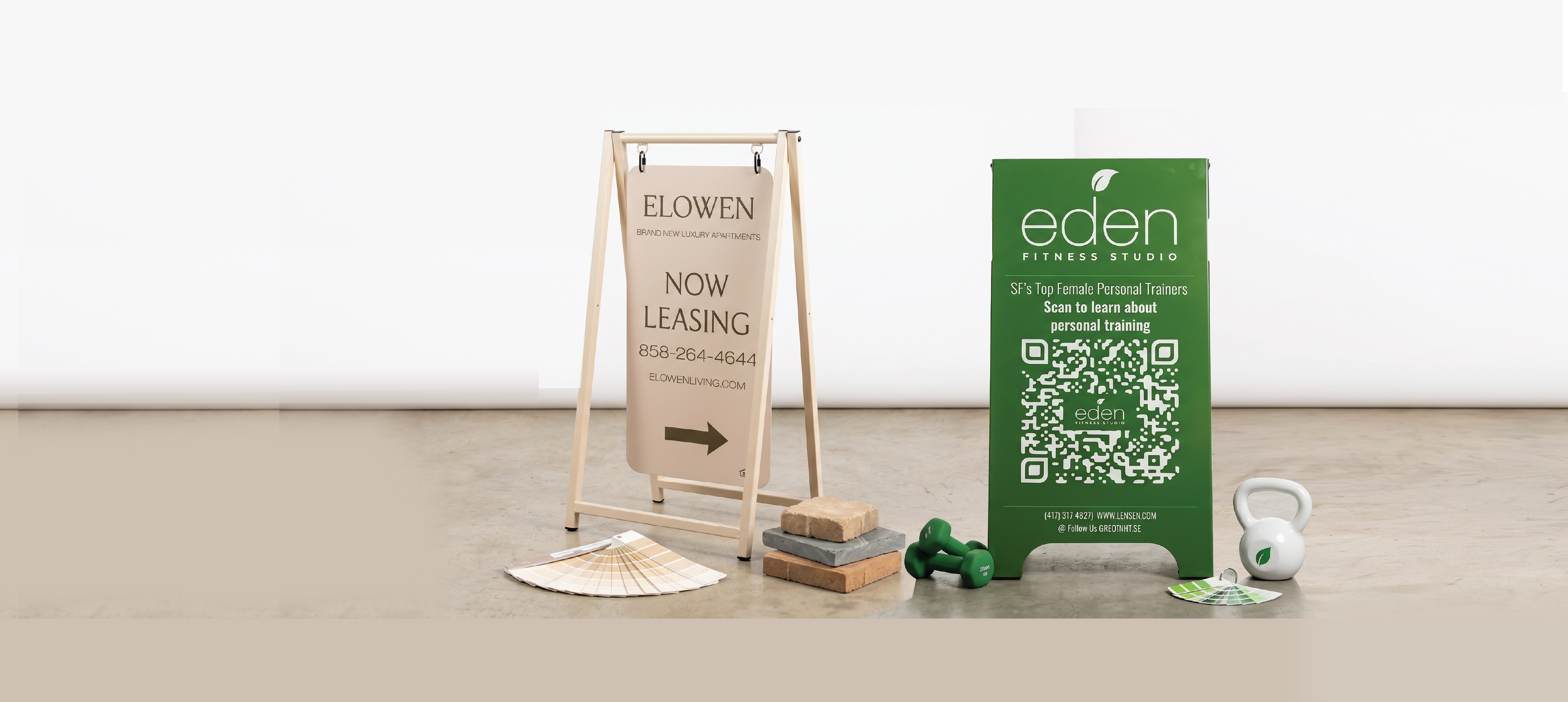 Custom powder coated sidewalk signs on a concrete floor with a white background