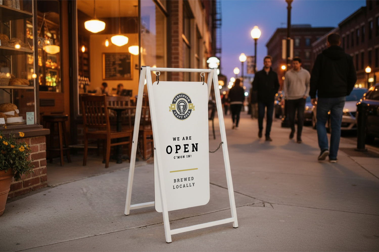 White a frame sidewalk sign at dusk outside a bar