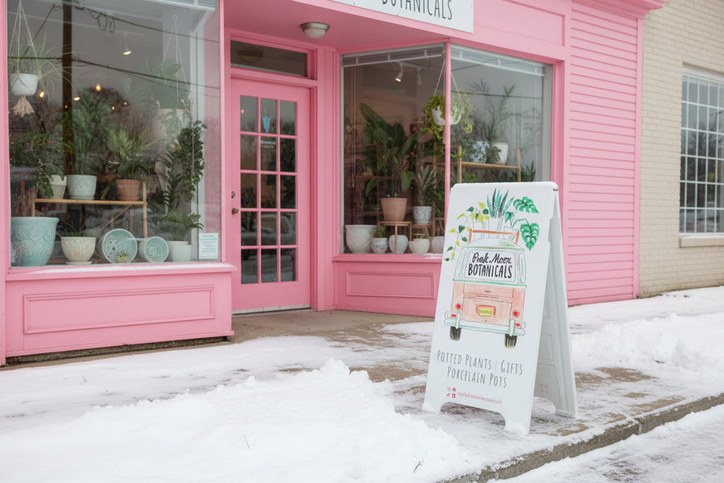 Sidewalk sign wrapped in graphics of a botanical design on a sidewalk