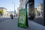 Eden Fitness green metal sidewalk sign with QR code