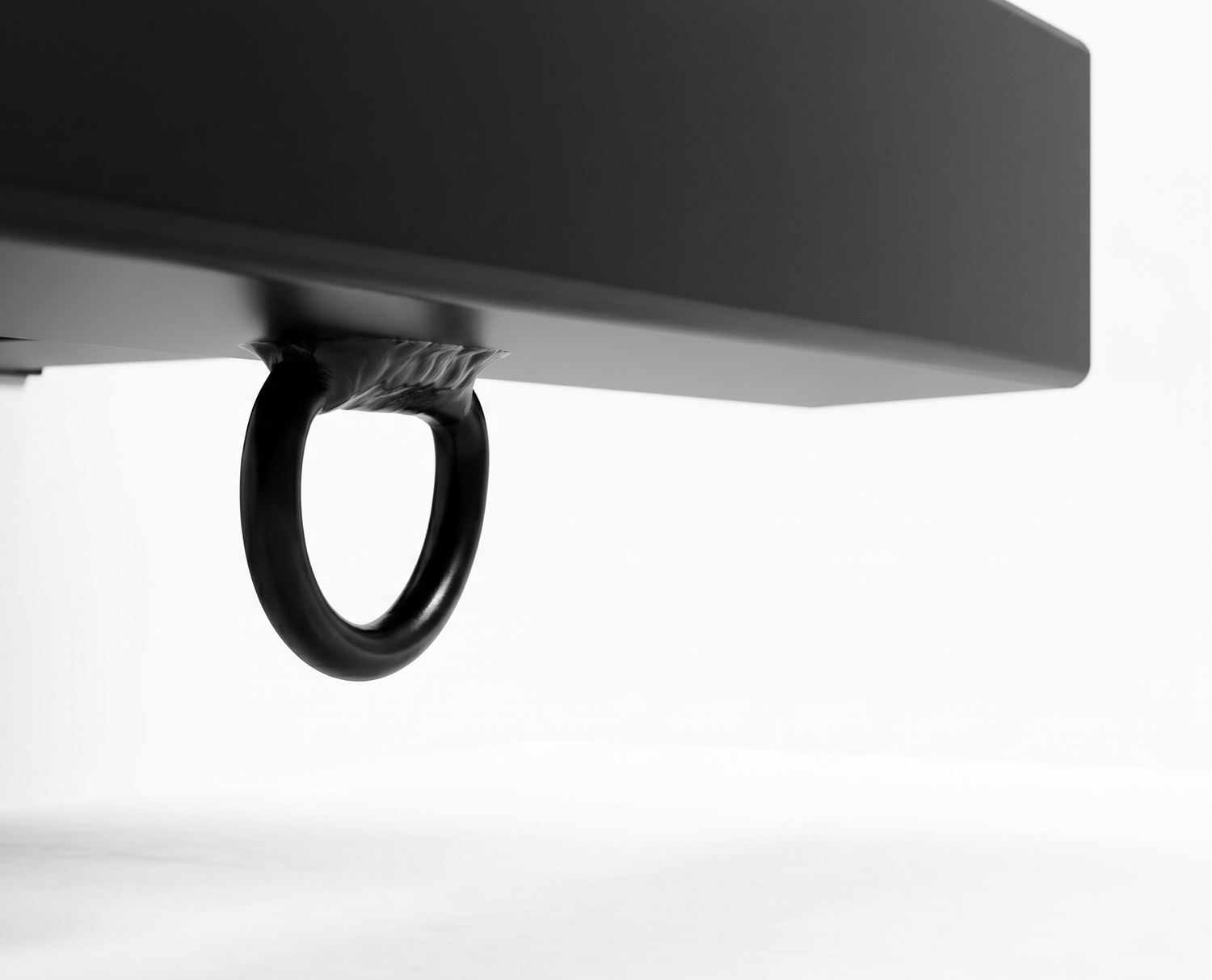Close-up of a black metal ring handle mounted beneath a matte black sign bracket, shown against a clean white studio background.
