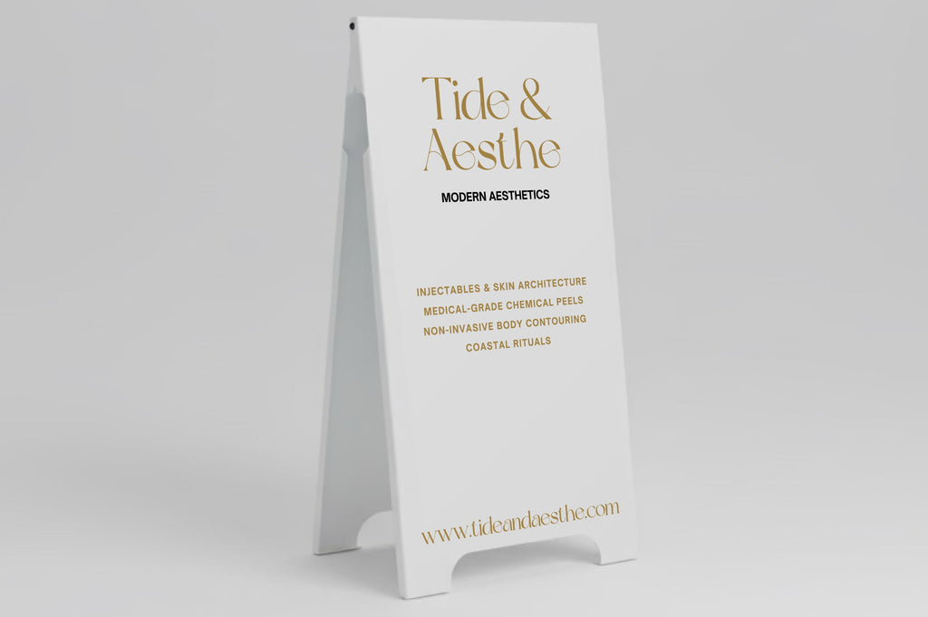 Tide & Aesthe sign on a stand against a gray background